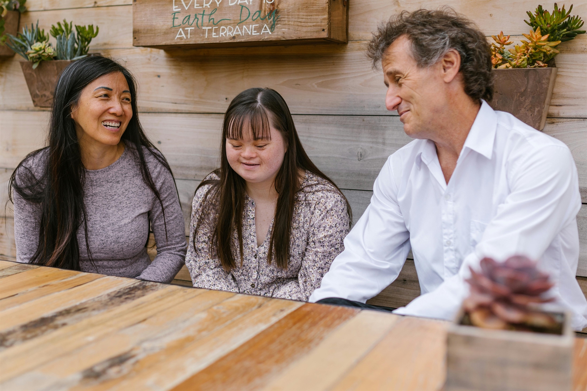 Mom Dad and young girl sitting at a table